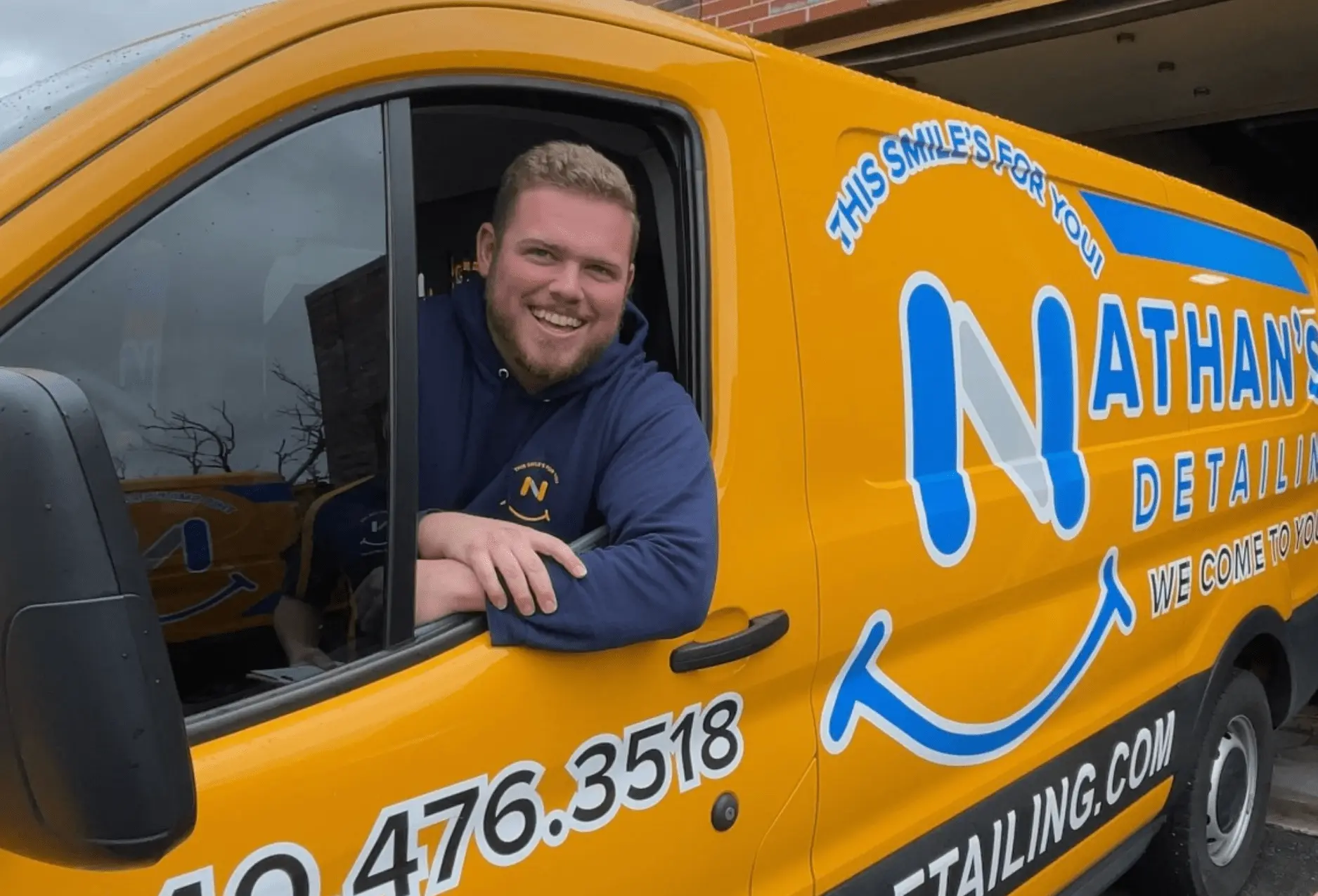 A happy Nathan's Detailing employee pulling our van out of the shop.